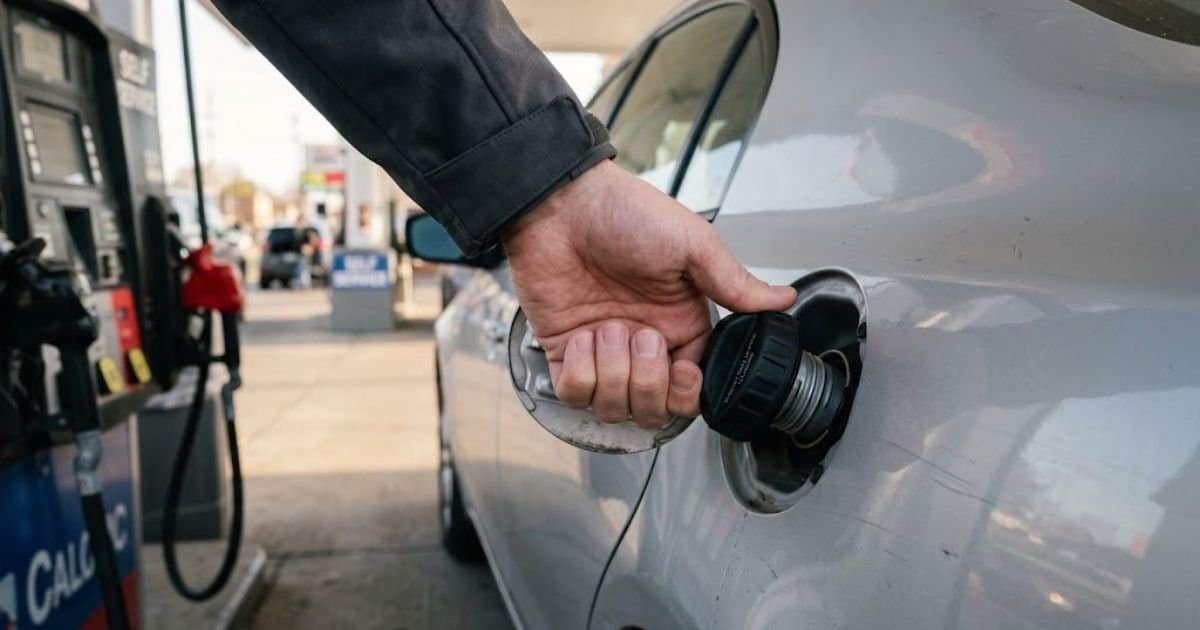 Driver tightening gas cap after refueling to fix check engine light