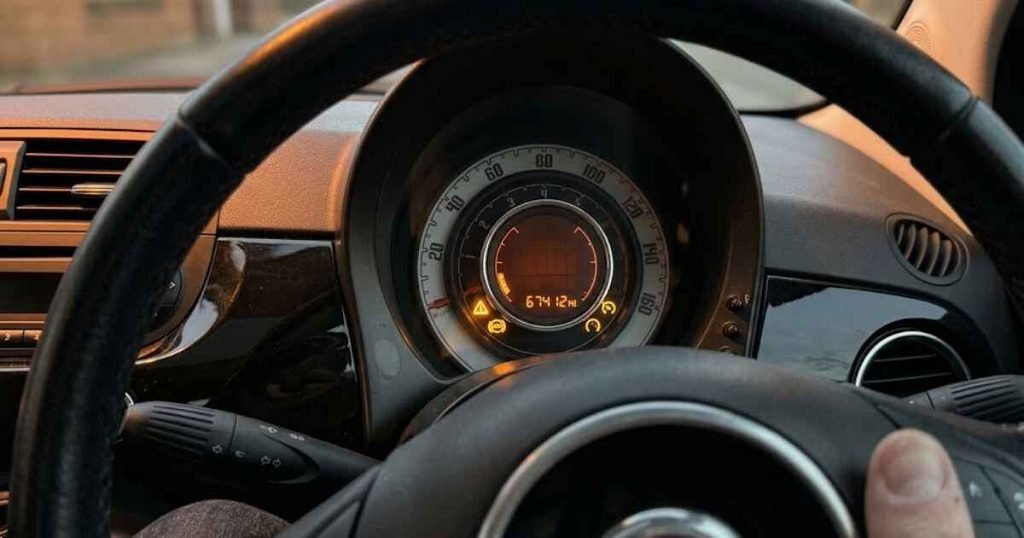Three amber warning lights on together on Fiat 500 cluster: triangle exclamation mark, ABS, and start-stop system indicators illuminated simultaneously