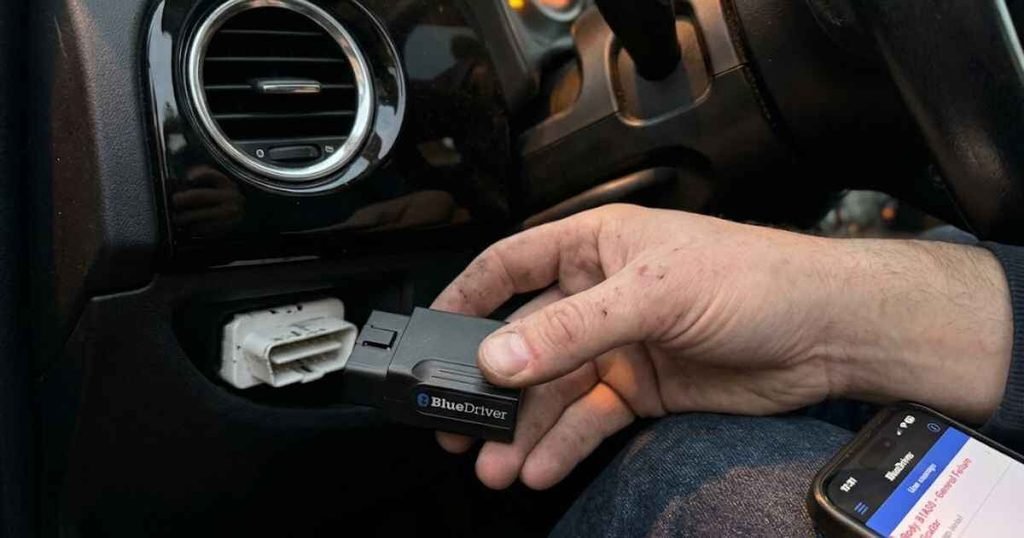 BlueDriver OBD-II scanner plugged into a 2014 Fiat 500 diagnostic port showing B1A00 general failure indicator fault code on smartphone screen
