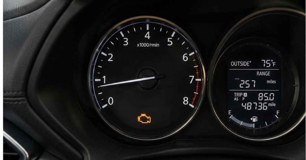 Mazda CX-5 dashboard showing an illuminated check engine warning light