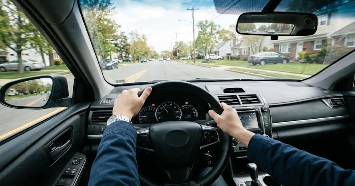Driver's view of the dashboard with the check engine light on while the car stutters